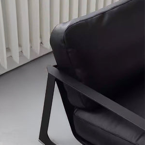 Black Lille Lounge Chair LC008 by BEACON featuring a modern, cushioned design with sleek black upholstery and wooden legs.