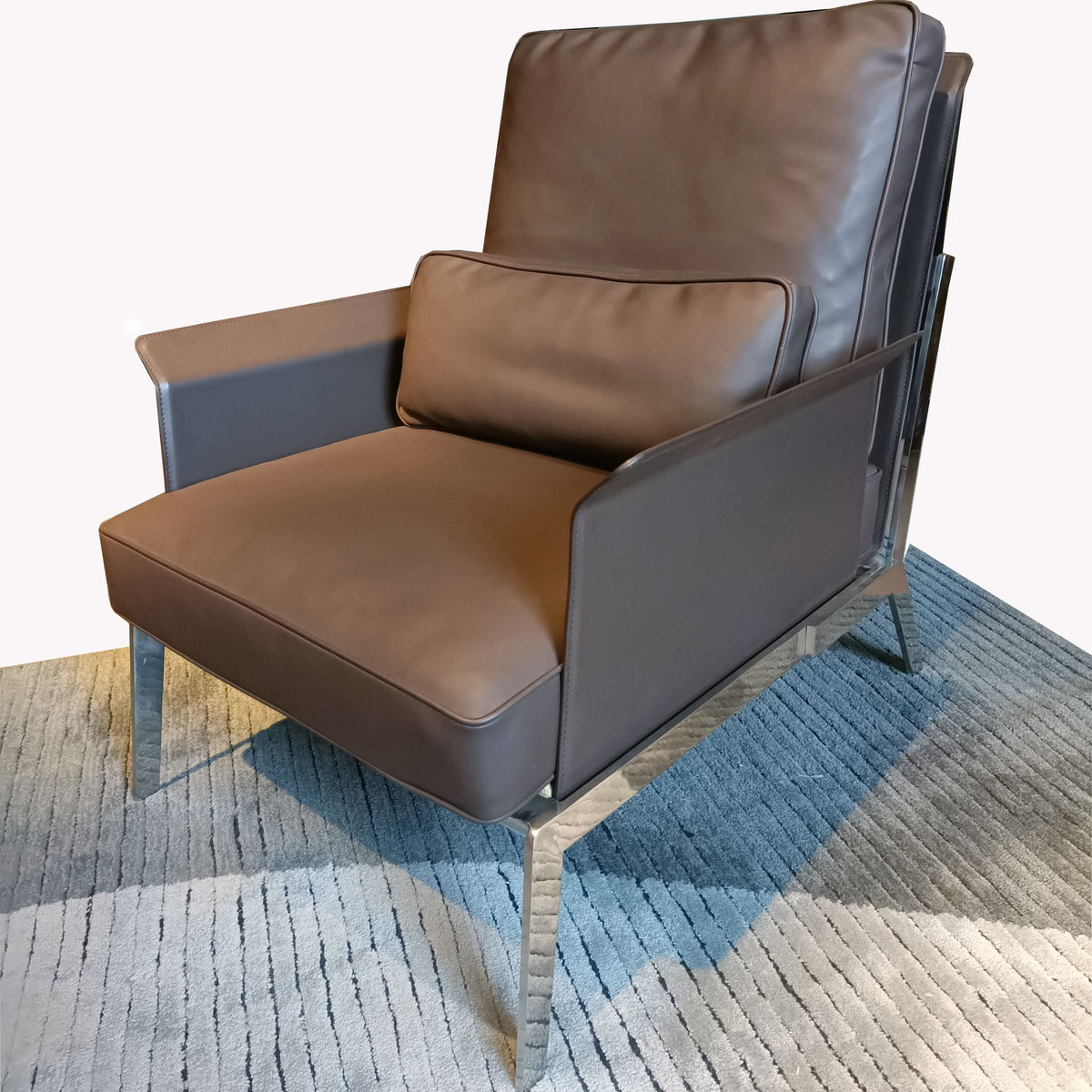 Modern BEACON lounge chair LC069 with a sleek design, featuring cushioned seat and backrest in a stylish living room setting.