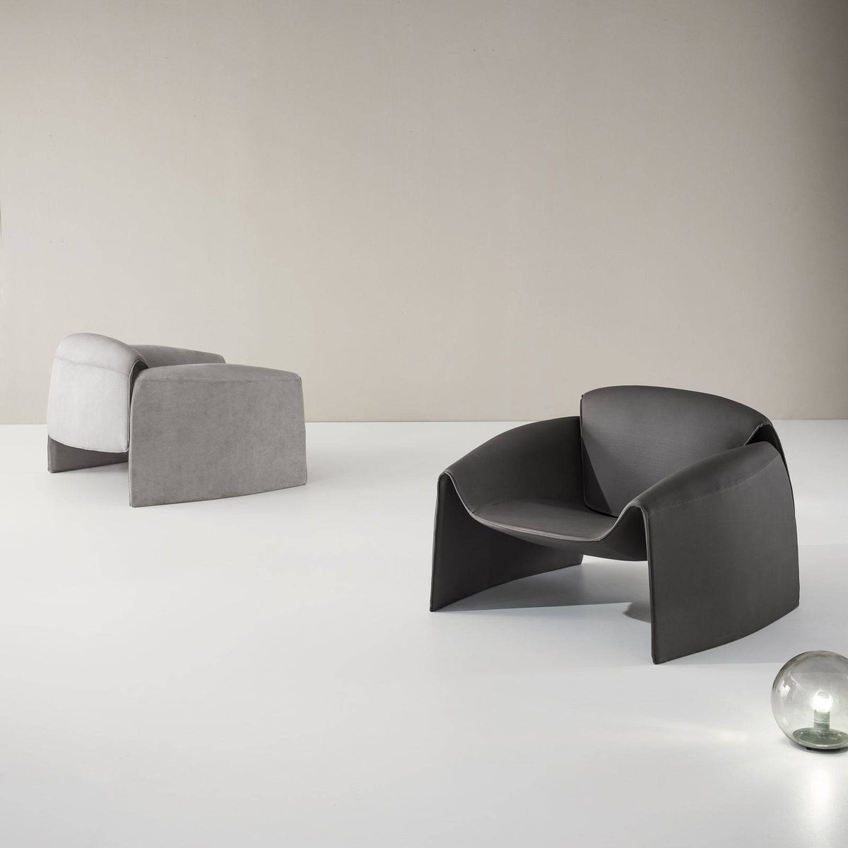Grey Drancy armchair by BEACON with a modern design, featuring a cushioned seat and stylish armrests.