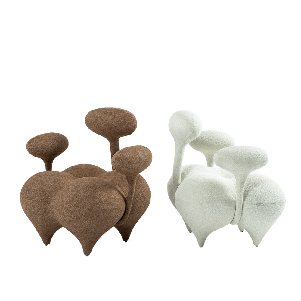 Beige and white Nodus lounge chair by BEACON with sleek modern design, padded seat and armrests for comfort.