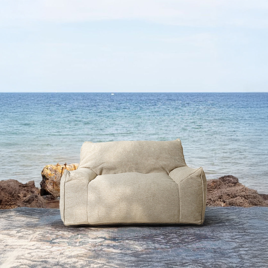 BEACON Olefin lounge chair with cushioned seat and armrests, modern design in neutral fabric, ideal for living rooms.