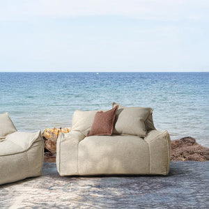 BEACON Olefin lounge chair with cushioned seat and backrest, modern design, in a cozy living room setting.