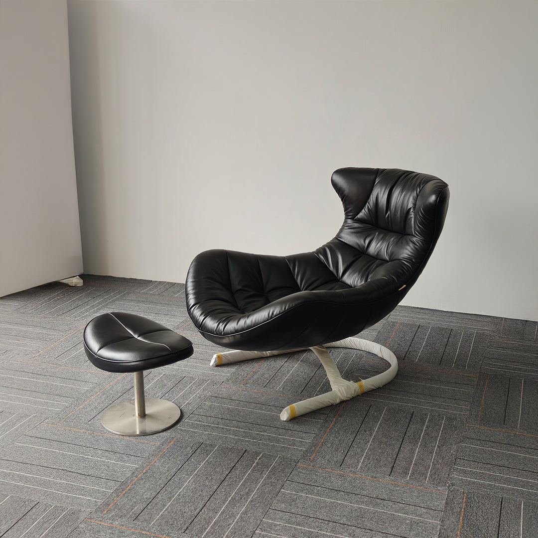 Vexel black lounge chair with matching ottoman by BEACON, modern design for comfortable seating and relaxation.