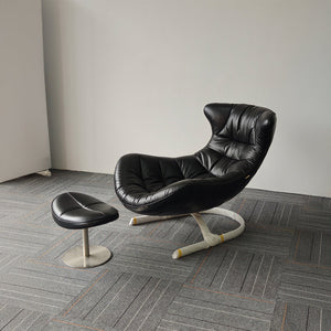 Vexel black lounge chair with matching ottoman by BEACON, modern design for comfortable seating and relaxation.