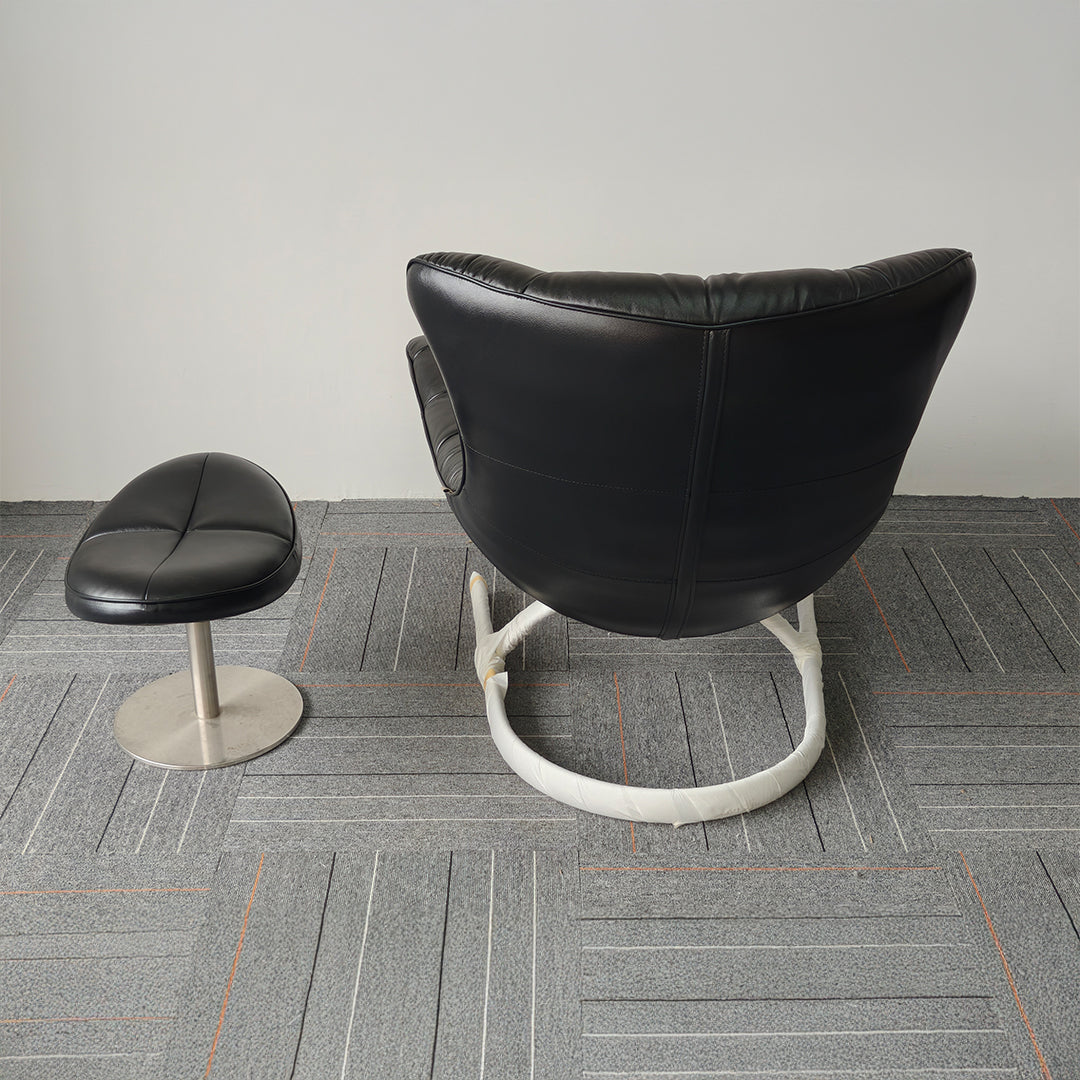 Black Vexel lounge chair with matching ottoman by BEACON, modern design, comfortable seating for living room relaxation.